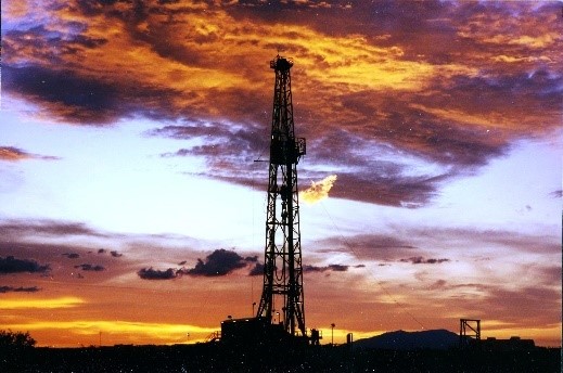 Drilling a well at sunset